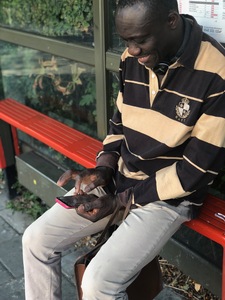 An over 45+ gaming whilst waiting for his bus. 